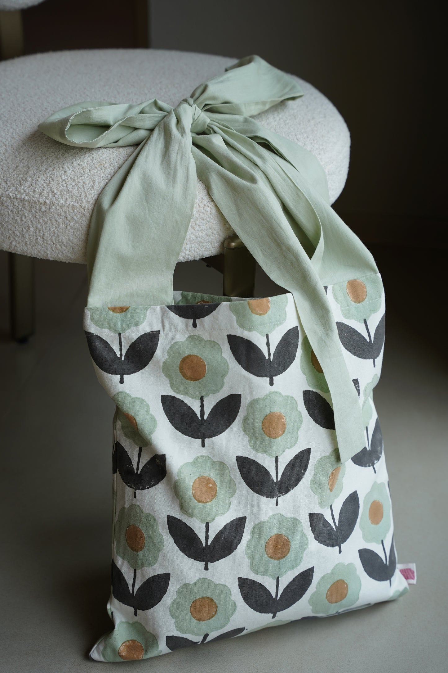 Fabric bag with floral pattern tied