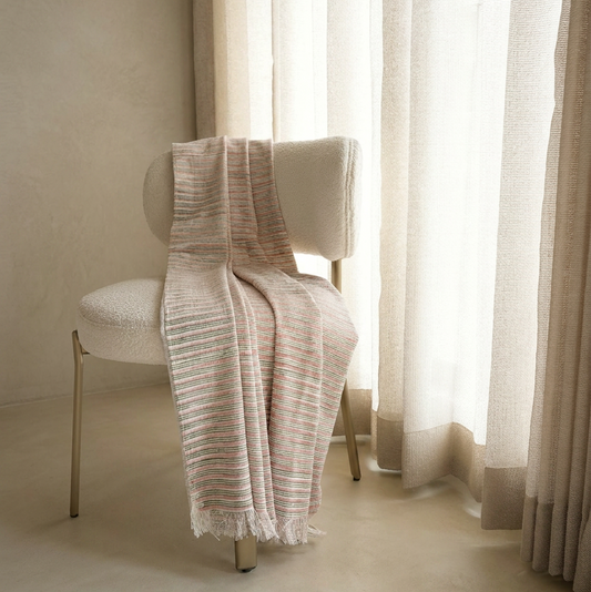 Staircase with pleated white curtains on a plain wall