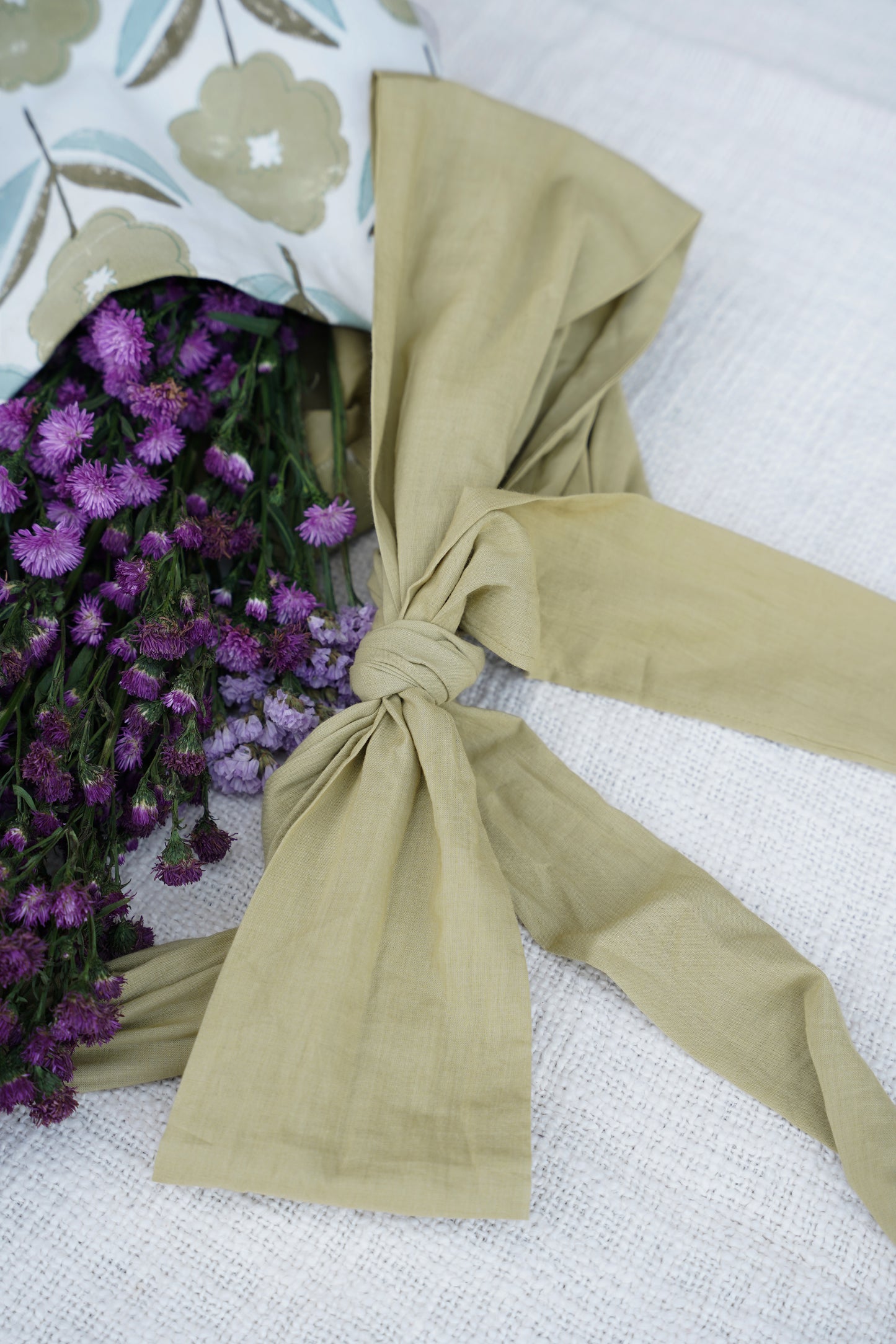 Beige ribbon on a floral-patterned fabric.