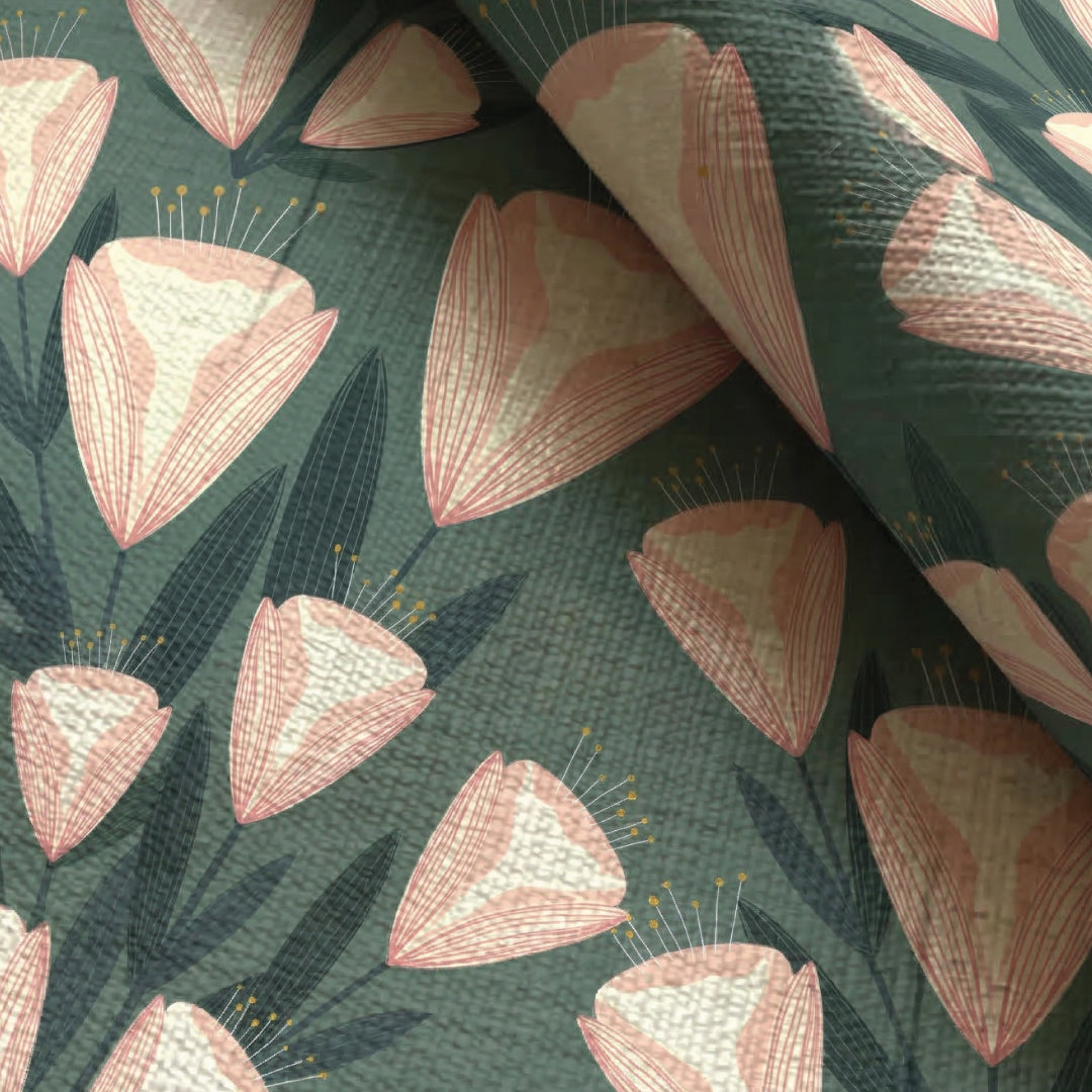 Close-up of a fabric with pink floral pattern on a green background
