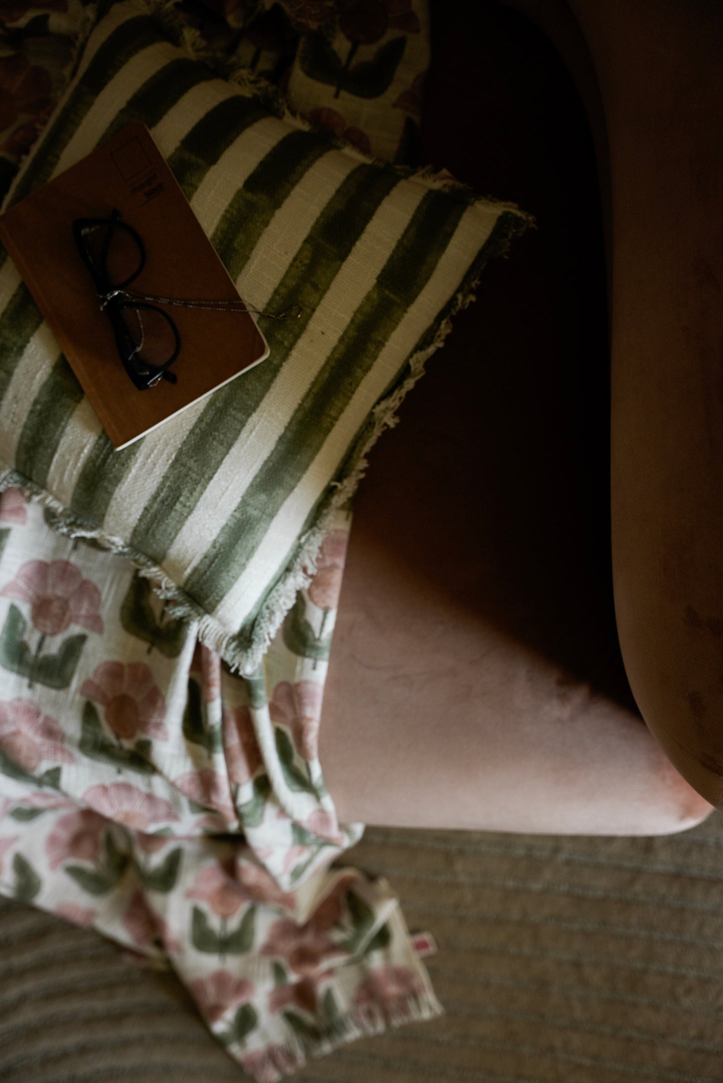 Close-up of a person wearing a striped dress with floral patterns on a couch.