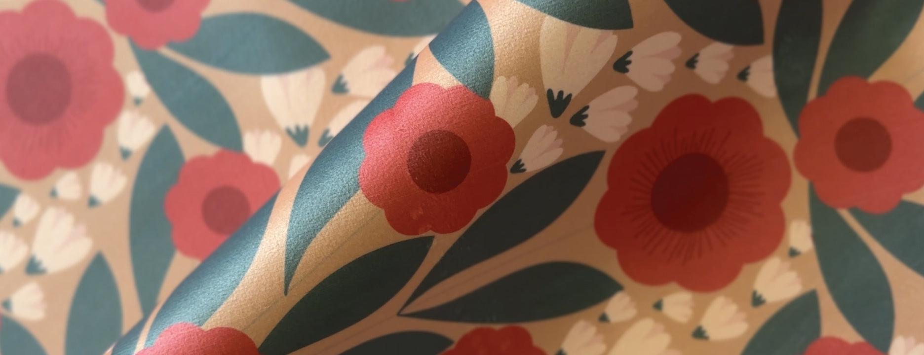 Floral pattern with red flowers and green leaves on a beige background
